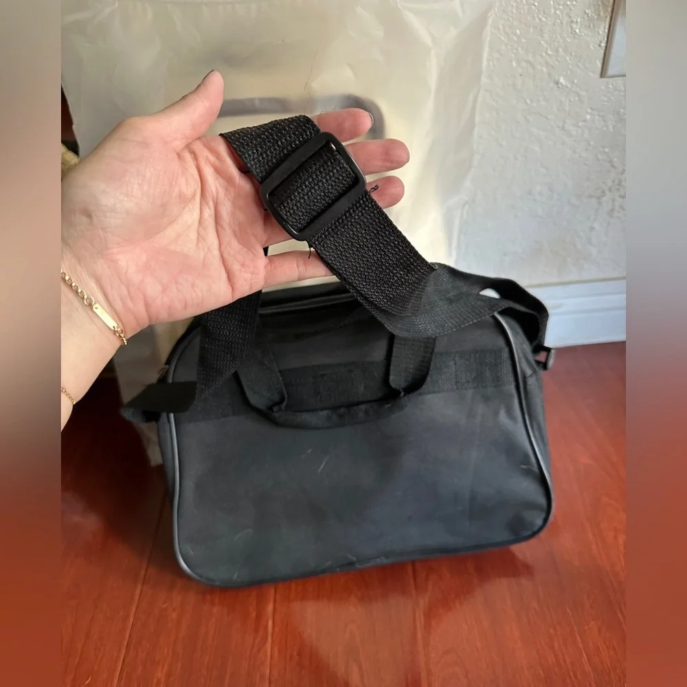 Men’s minimalist black carrying bag for travel or everyday use. Airplane logo.